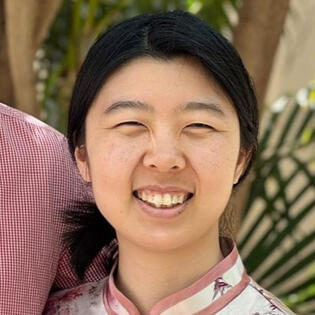 A circular portrait of Sisi Peng, a smiling Asian-American woman with black hair.